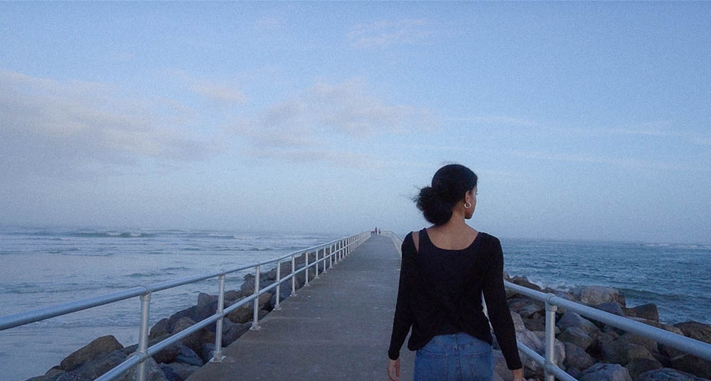 Nikki walking on the pier